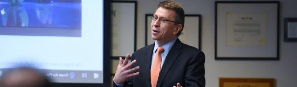 Image of Dean Matthew Rousu speaking in front of a classroom.